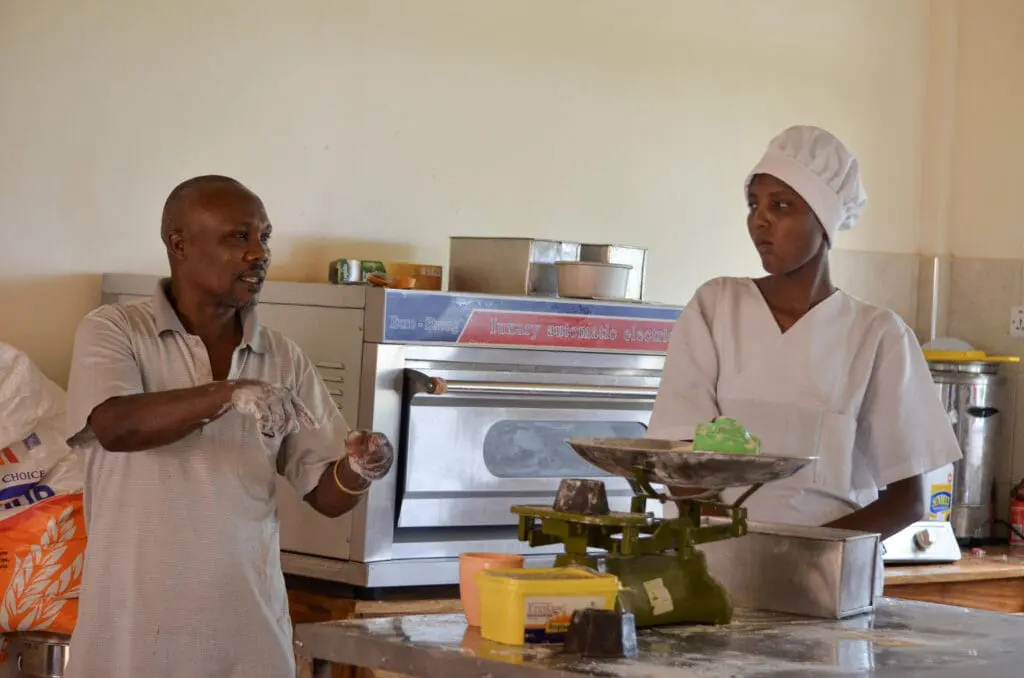 Baker and assistant in kitchen